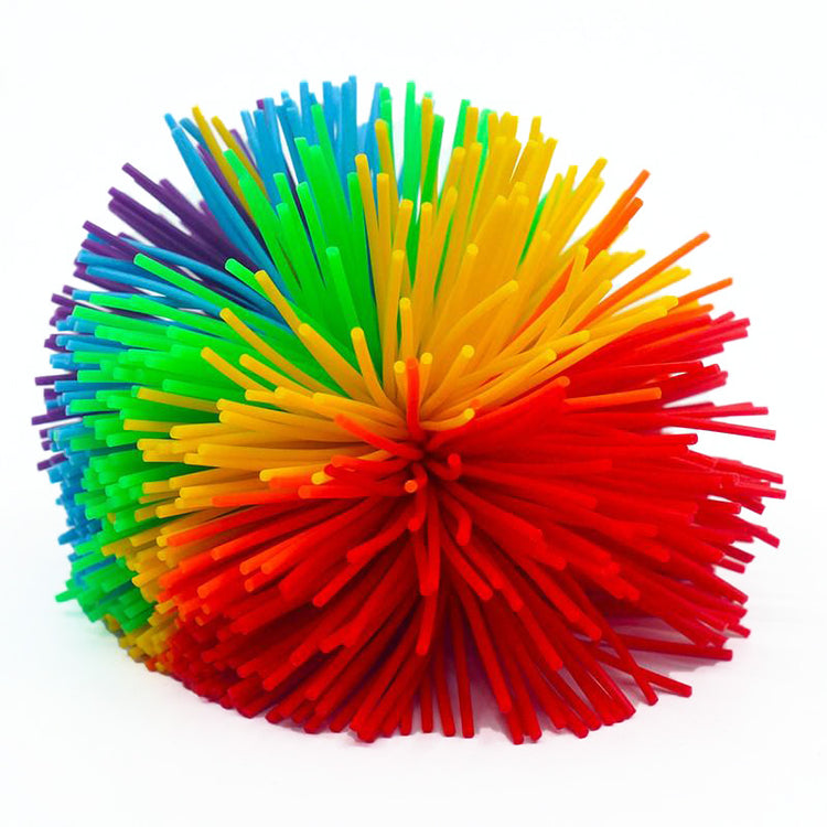 A multicolored Koosh ball with a vibrant array of rubber bands creating a visually appealing pattern.