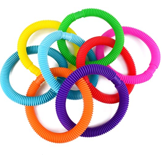 A collection of colorful rubber pop tubes arranged in a circular pattern.