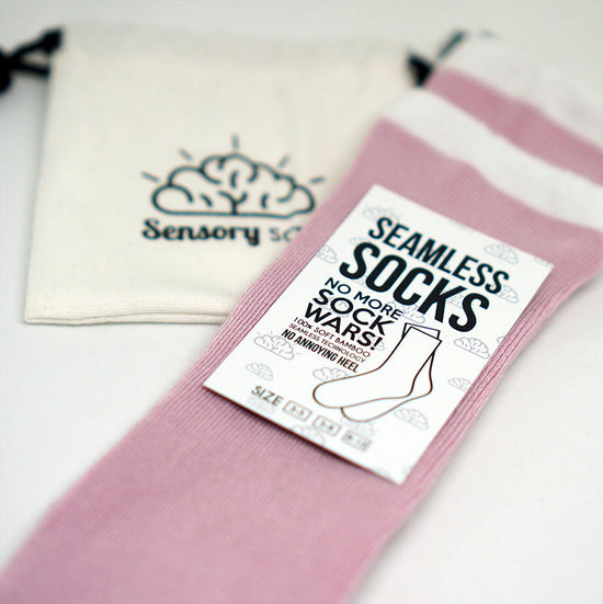 A two-pack of pink seamless socks with a rose design and a white band, labeled &