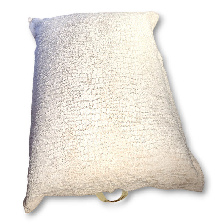 Beige textured sensory crash pad with carrying handle on a white background
