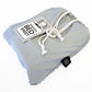 A gray sensory bed sheet made of Lycra/Spandex, packaged and tied with a string, with a product tag attached.