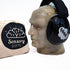 A pair of black ear muffs designed for children, displayed on a mannequin head, next to a bag with the logo &