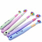 A collection of three-sided toothbrushes in various colors including pink, green, and blue.