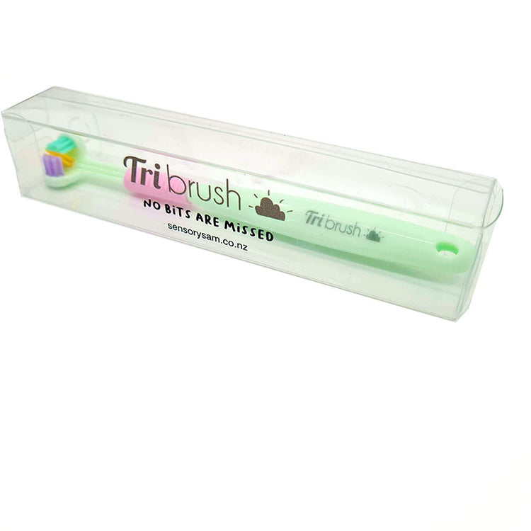 A collection of three-sided toothbrushes in various colors including pink, green, and blue.