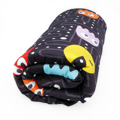 A folded weighted blanket with a colorful, arcade game-inspired design including characters and geometric shapes on a black background.